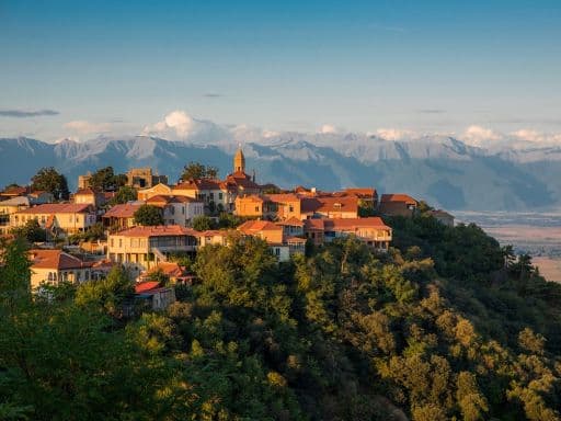 Signagni in winery region of Georgia, Kakheti, during sunset in summer with Caucasus mountains